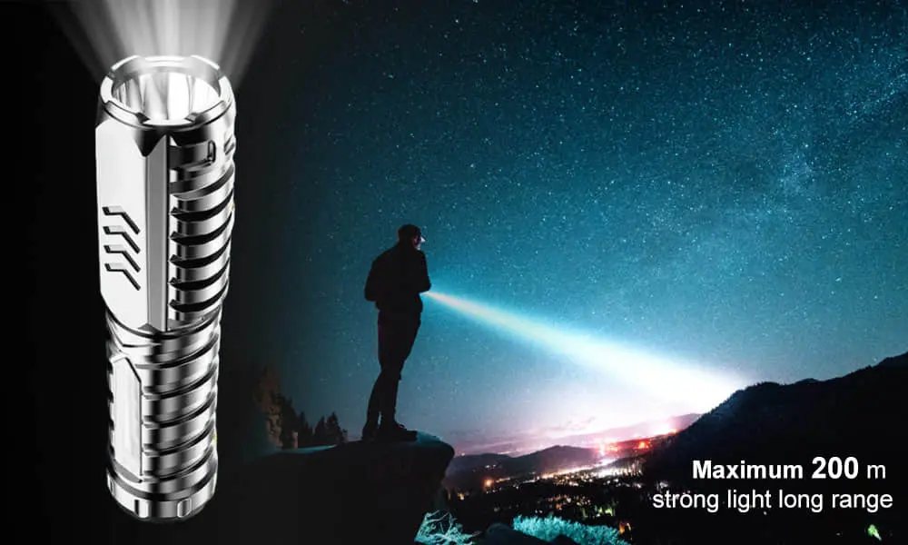 Night Spark flashlight with a long beam lighting up a hillside at night